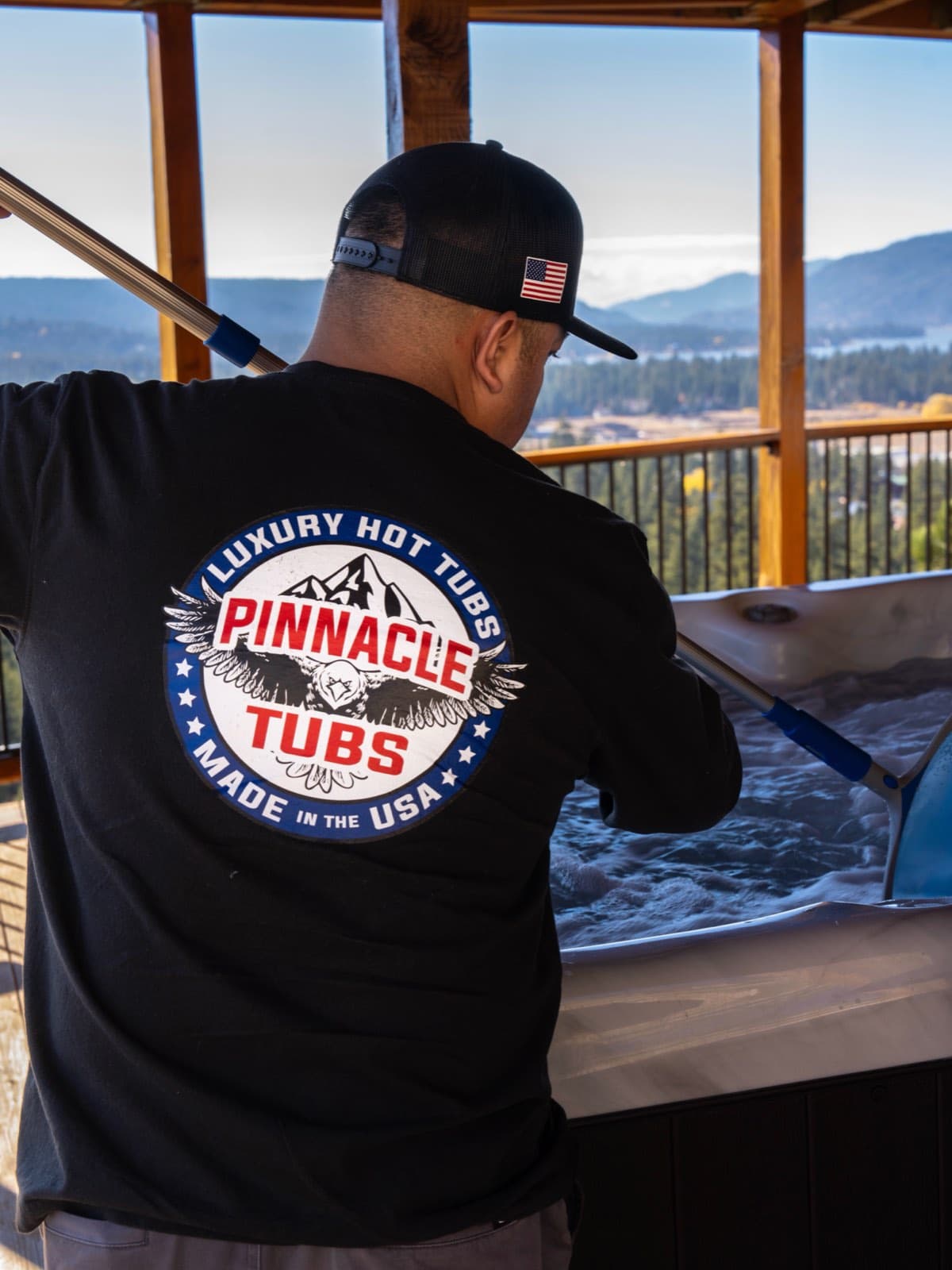 A Pinnacle Tubs technician servicing a tub above Big Bear Lake