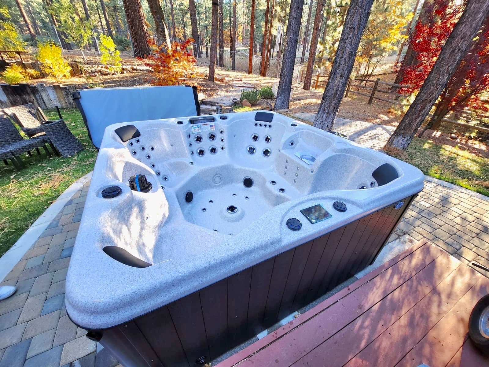New spa installed on a backyard patio in the pines