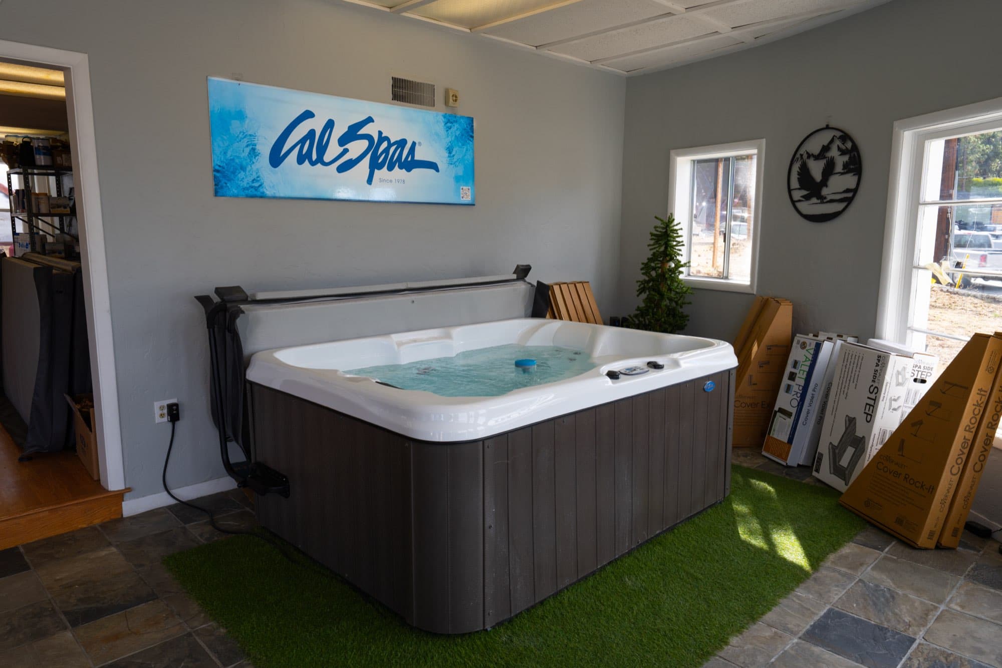 A showroom tub with steps and a cover lifter ready to go